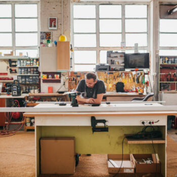 Carpenter making furniture and drawing a sketch Carpenter making furniture and drawing a sketch